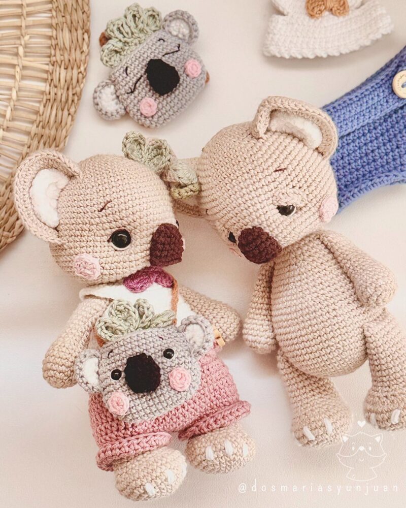 Side-by-side view of Benna the crochet koala with her backpack and an unfinished Benny doll. Extra pieces like a blue outfit and koala backpack head are also visible.