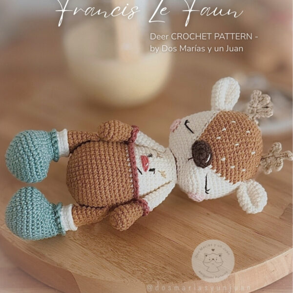 Cover image Digital PDF Crochet Pattern of Francis Le Faun, a handmade amigurumi deer. Detailed image of the finished fawn with sleepy eyes and teal boots on a wooden tray. Designed by Dos Marías y un Juan.